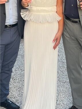 Elegant Cream Pleated Wedding Dress with Peplum Detail